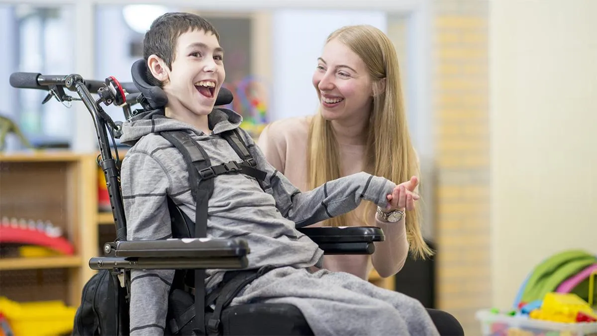 Child in wheelchair with caregiver